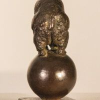 Alt text: Bronze sculpture of a bear balanced on a ball