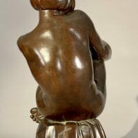Alt text: Bronze sculpture of a pensive woman