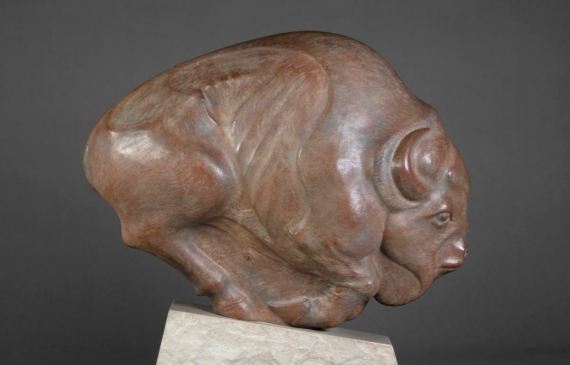 Alt text: Bronze sculpture of a running buffalo