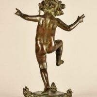 Alt text: Bronze sculpture of a skipping toddler