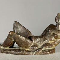 Alt text: Bronze sculpture of a reclining nude