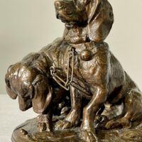 Alt text: Bronze sculpture of two dogs