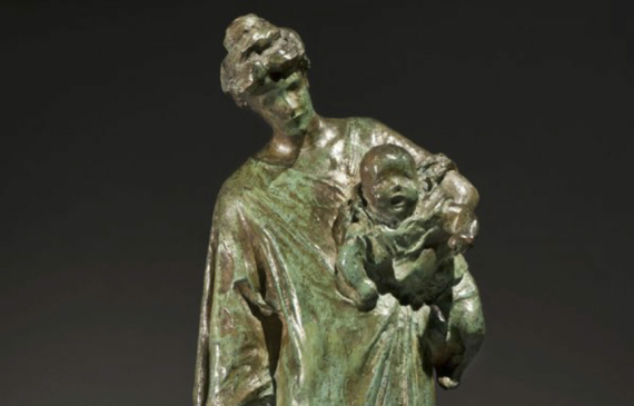 Alt text: Bronze sculpture of a mother holding a baby
