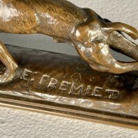 Alt text: signature detail of a bronze sculpture of a dog