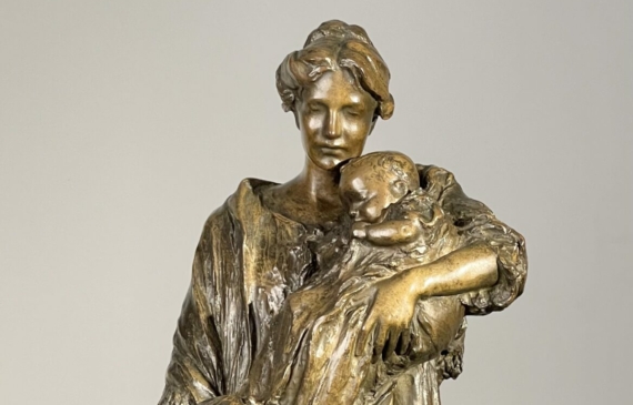 Alt text: Bronze sculpture of a mother with her baby and two daughters