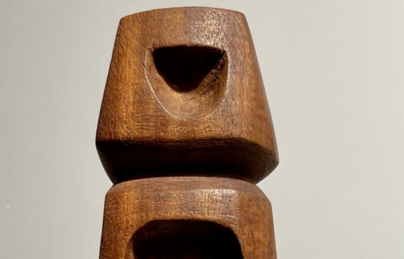 Alt text: Wood carving of a totem