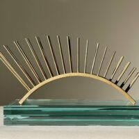 Alt text: metal sculpture with spikes on glass base