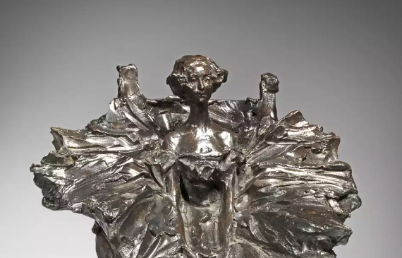 Alt text: Bronze sculpture of a seated dancer