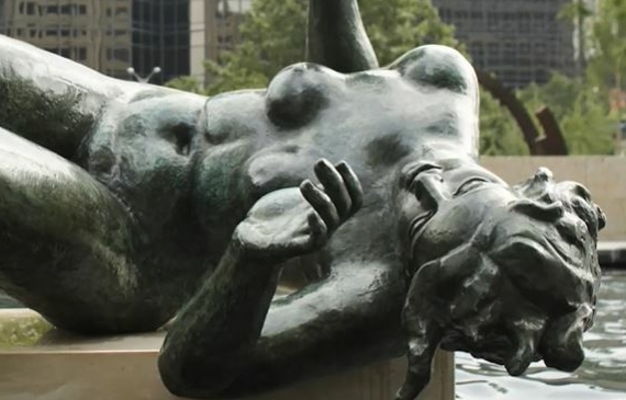 Alt text: A bronze sculpture of a reclining figure