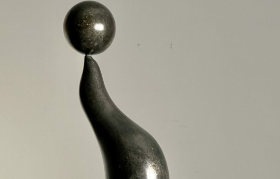 Alt text: Bronze sculpture of a seal with a ball