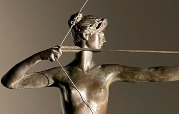 Alt text: Bronze sculpture of a woman holding a bow and arrow