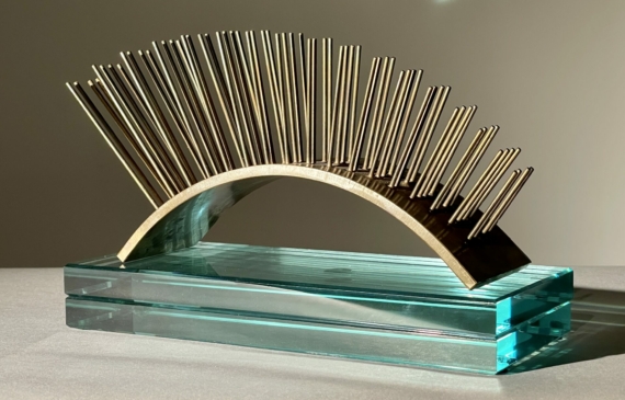 Alt text: metal sculpture with spikes on glass base