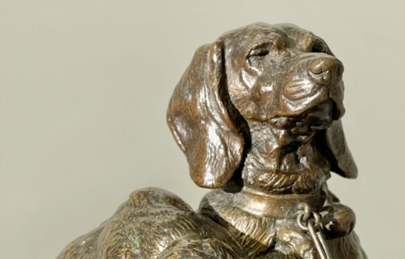 Alt text: Bronze sculpture of two dogs