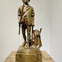 Alt text: Bronze sculpture of a man with a rifle