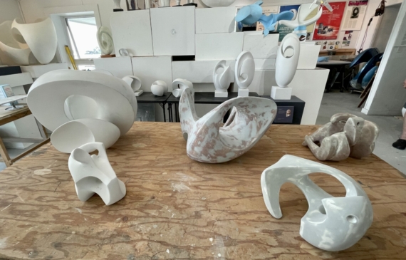 Alt text: photo of an artist's studio with unfinished sculptures