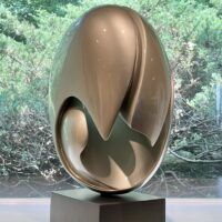 Alt text: glossy, oval shaped sculpture