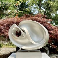 Alt text: silver, oval shaped sculpture