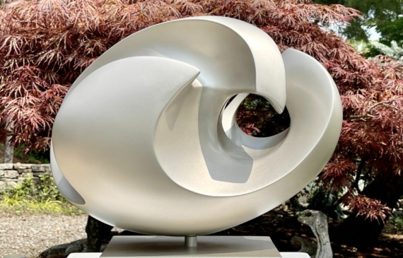 Alt text: silver, oval shaped sculpture