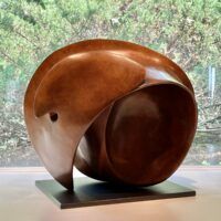 Alt text: bronze, oval shaped sculpture