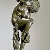 Alt text: Bronze sculpture of a woman looking down