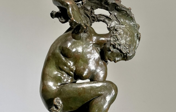 Alt text: Bronze sculpture of a woman looking down