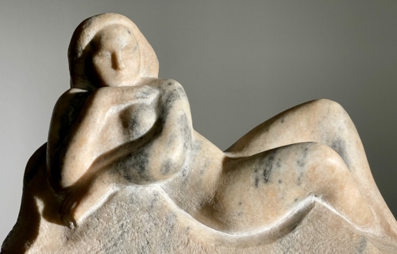 Alt text: Marble carving of a reclining nude woman