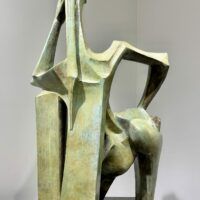 Alt text: Green sculpture of a standing woman
