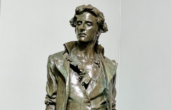 Alt text: Bronze sculpture of a standing man