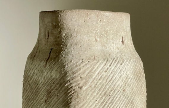 Alt text: White ceramic vase