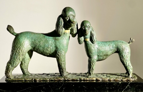 Alt text: Bronze sculpture of two poodles