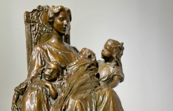 Alt text: Sculpture of a seated woman with children