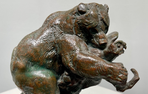 Alt text: Bronze sculpture of a bear catching an owl in his maw