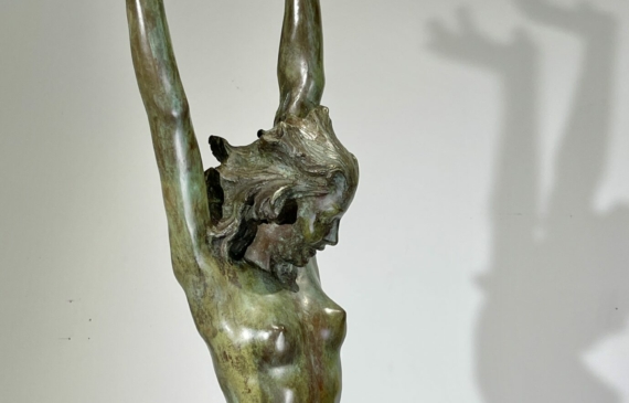 Alt text: Bronze sculpture of a standing woman