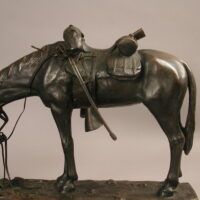 Alt text: Bronze sculpture of a figure kneeling in front of a horse