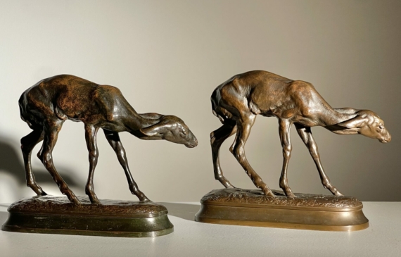 Alt text: Two bronze sculpture of fawns, side by side